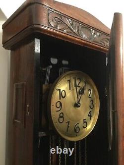Tall grandfather clock weight suspended chains driven pendulum dark wood