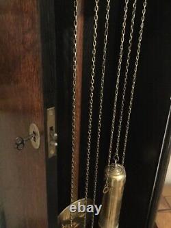Tall grandfather clock weight suspended chains driven pendulum dark wood